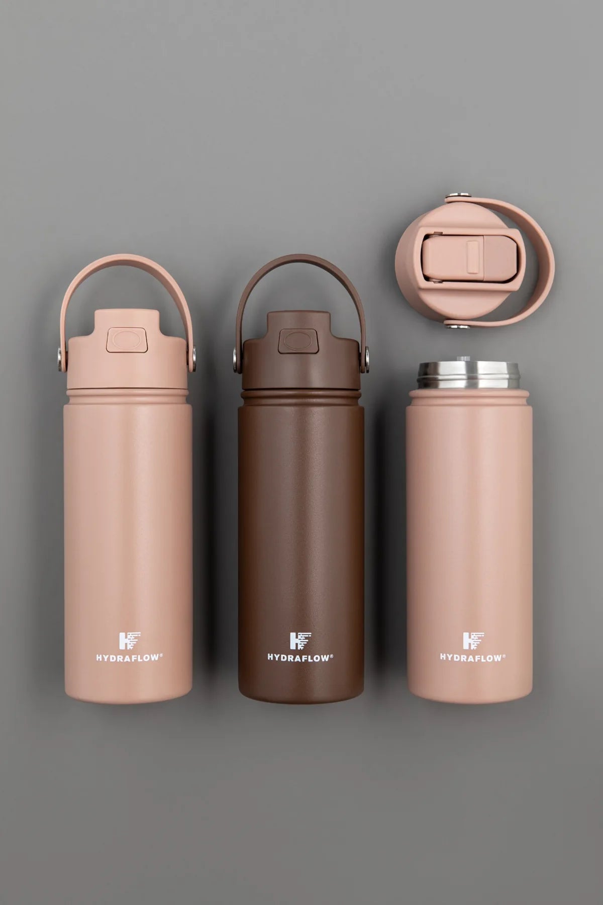 Rose and bronze Hydraflow bottles with contrasting lids in a studio arrangement