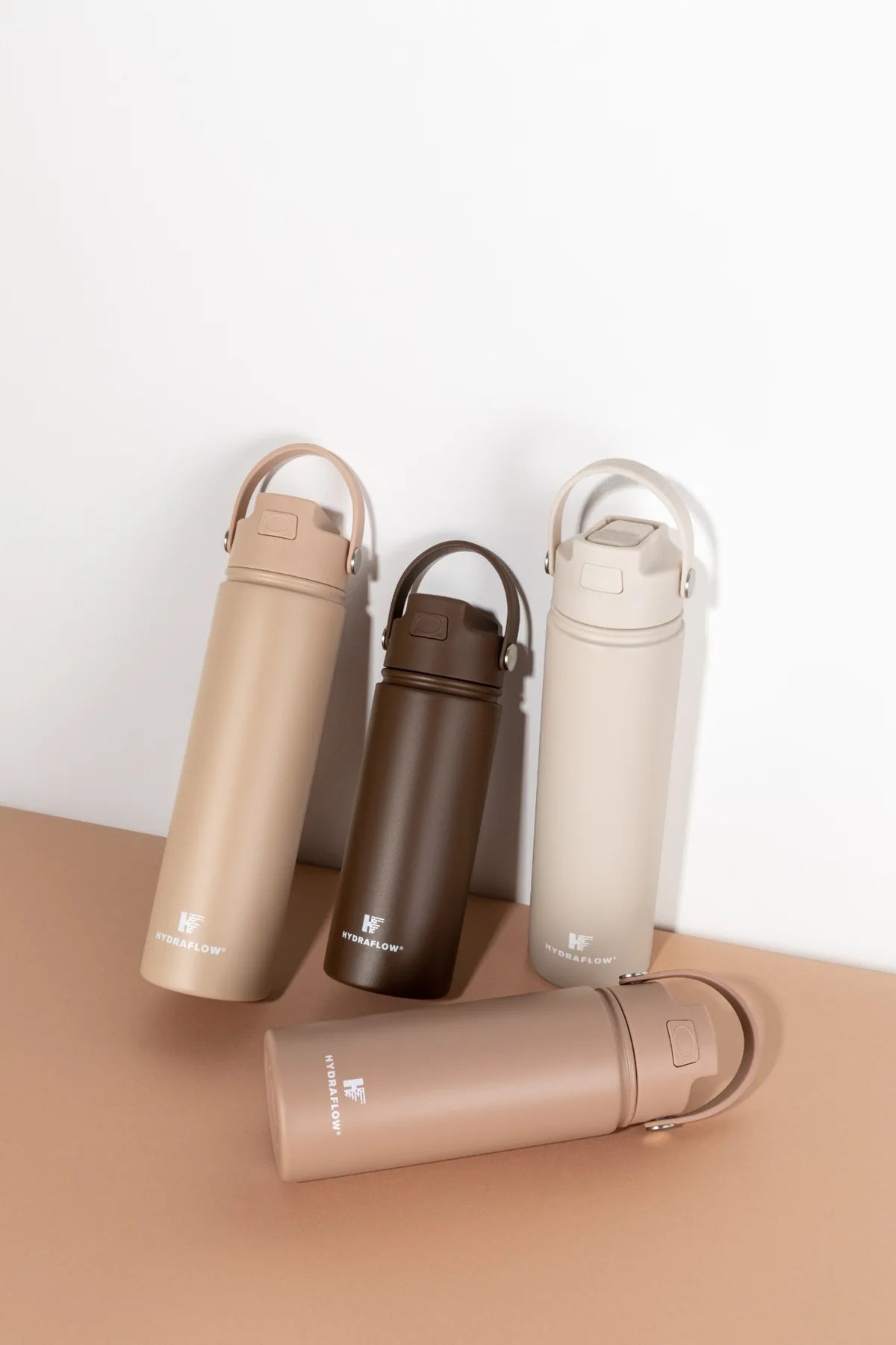 Hydraflow bottles in coordinated neutral tones on studio plinths